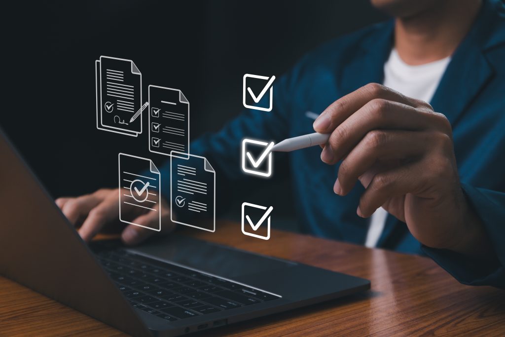 Person checking documents on laptop