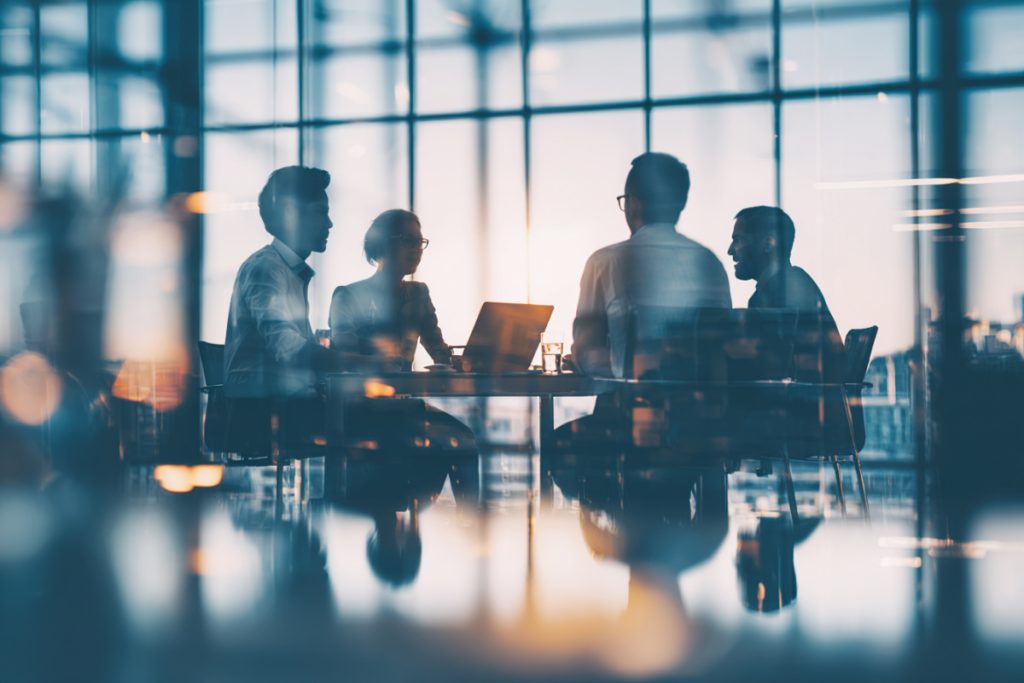 Silhouetted people in a meeting