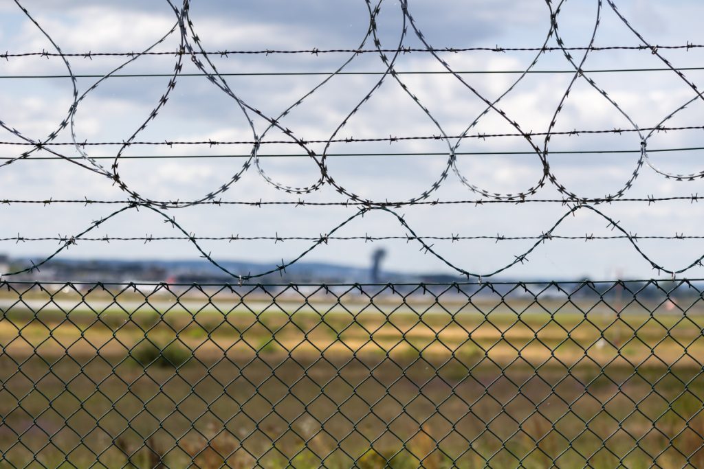 Barbed wire fence with distant landscape