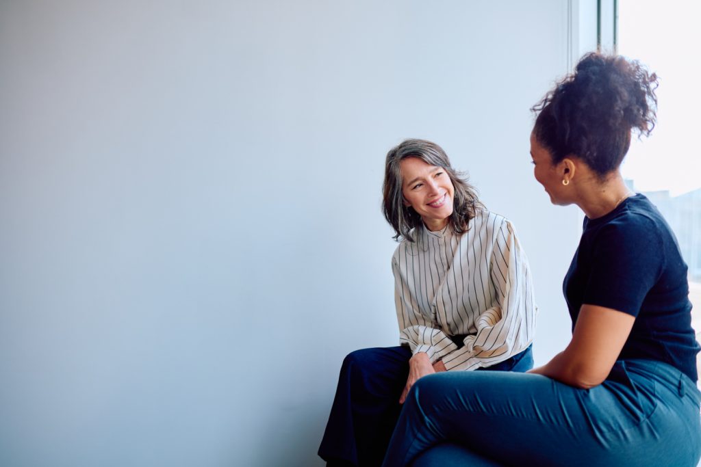 Two women engaged in conversation.