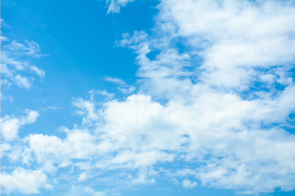 Bright blue sky with fluffy clouds