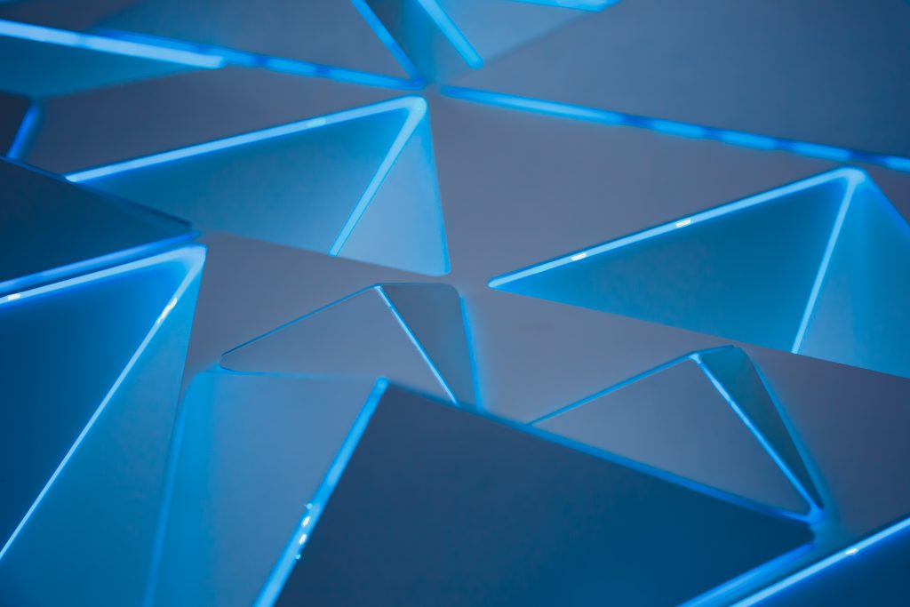 Geometric shapes illuminated in blue.